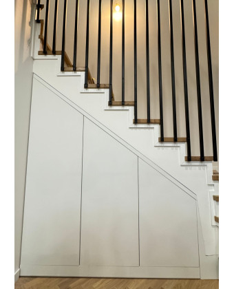 White cabinetry under the stairs