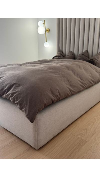 Beige panel bed with a high headboard for the bedroom