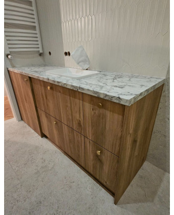 Custom-made bathroom cabinetry made of natural wood with a marble countertop, Poznań.