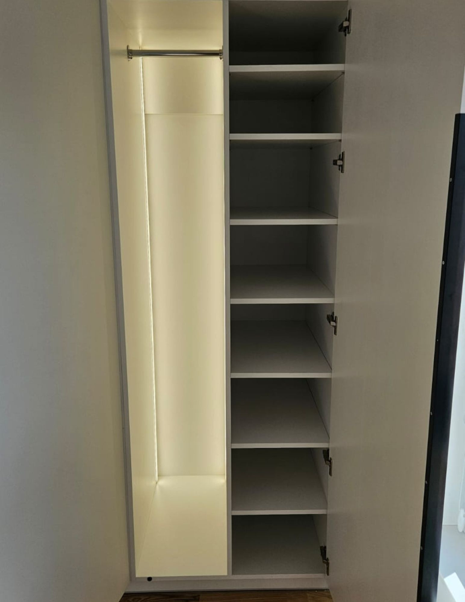 A white custom-made wardrobe with tall black handles—an elegant and functional storage solution. A white custom-made wardrobe with tall black handles—an elegant and functional storage solution.