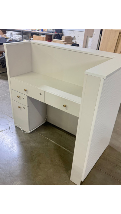 A rounded reception desk with a grooved front—modern and elegant