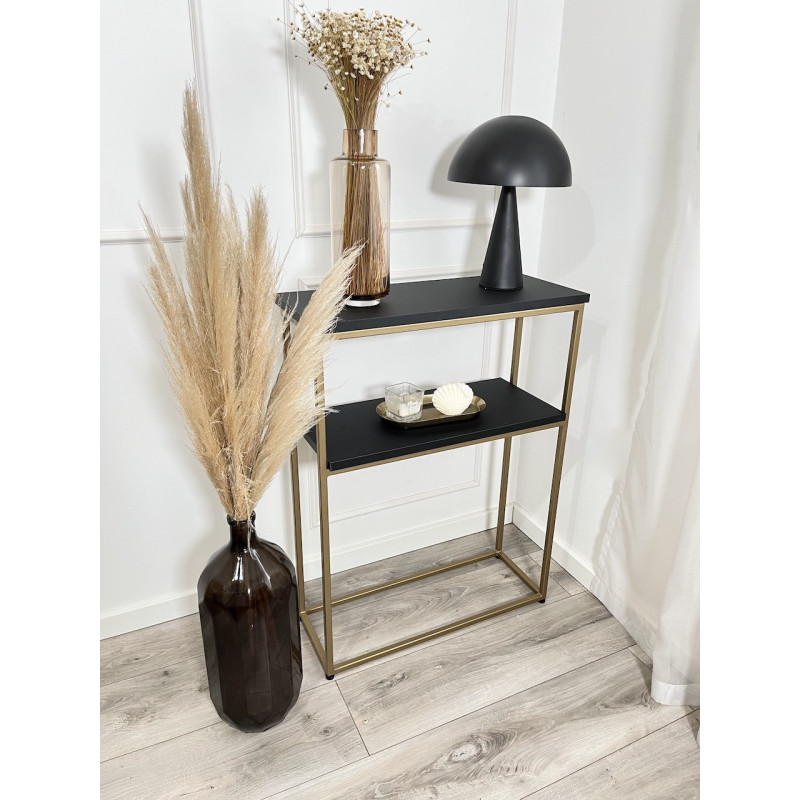 Czarno-złota nowoczesna konsola na metalowych nogach w minimalistycznym wnętrzu Czarno-złota nowoczesna konsola na metalowych nogach w minimalistycznym wnętrzu