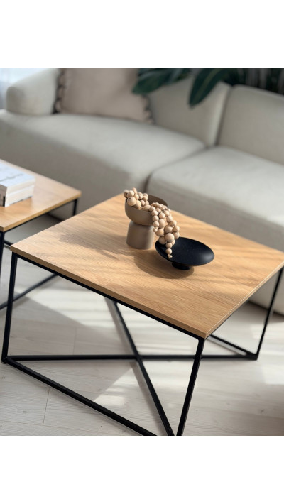 two wooden coffee tables with black metal frames for the living room