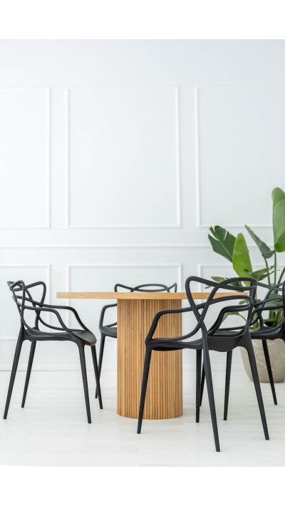 A minimalist dining table with a grooved base